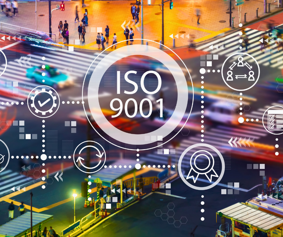 Artigo 3 Maio 2026 I - Vexillum Urban city intersection overlaid with ISO 9001 certification graphics, symbols of quality management like circles, checkmarks, and ribbons.